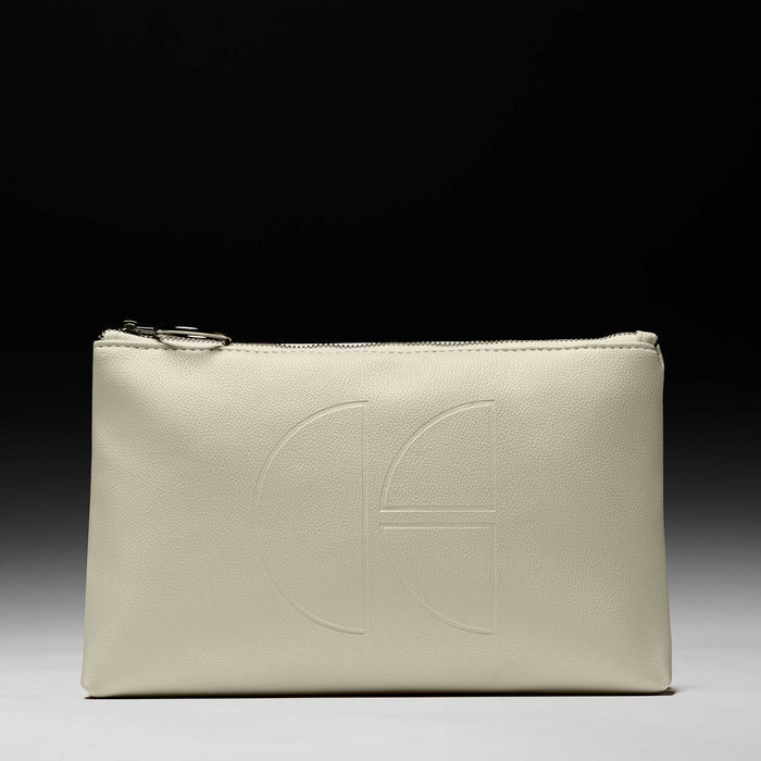 Cécred beige travel bag with embossed logo on black-to-white gradient background