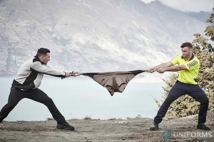 Two men stretching Syzmic Streetworx Tough Pants showcasing durability meets ultimate style